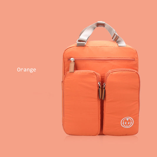 Orange backpack with a visible brand logo on a peach background