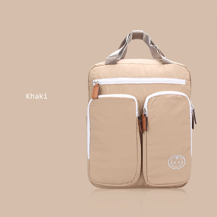 Khaki backpack with white zippers on a beige background