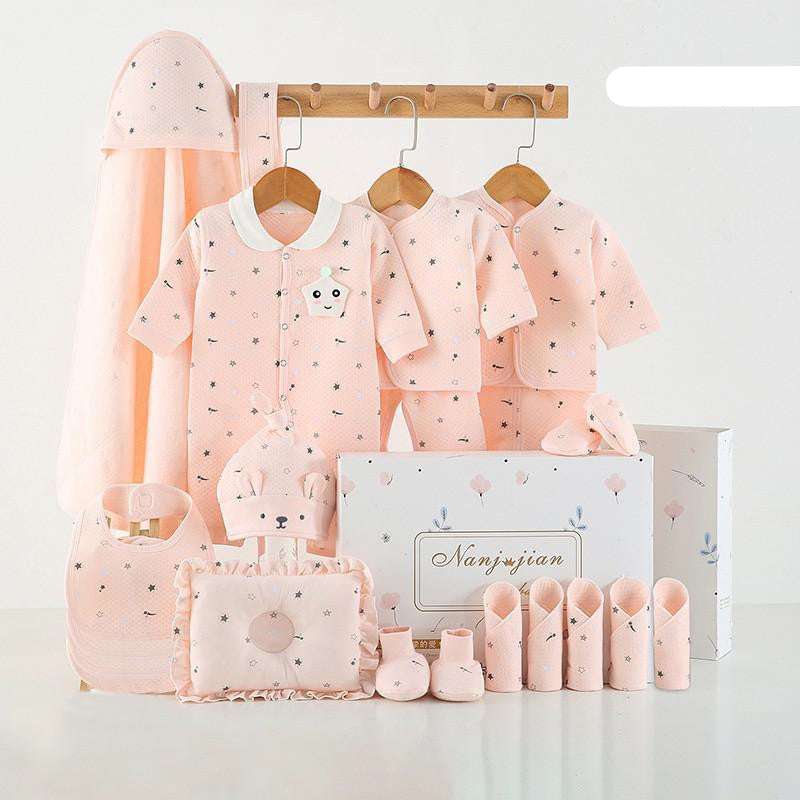 Baby clothing set with pink outfits, hats, and accessories on a white background.