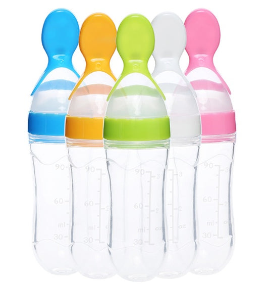Set of five colorful baby bottles with different colored caps on a white background