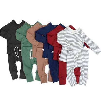 Row of colorful baby rompers on a white background