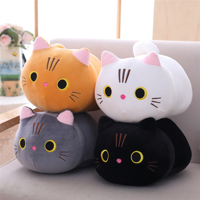 Four colorful cat-shaped cushions stacked on a surface with a blurred background.