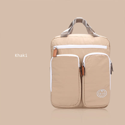 Khaki backpack with white zippers on a beige background
