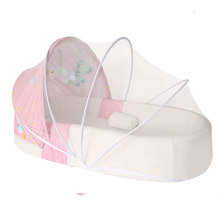 Pink and white baby crib with canopy on a white background