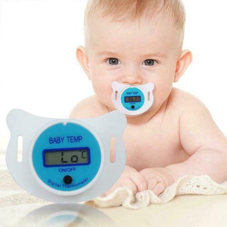 Baby with a digital thermometer pacifier on a white background