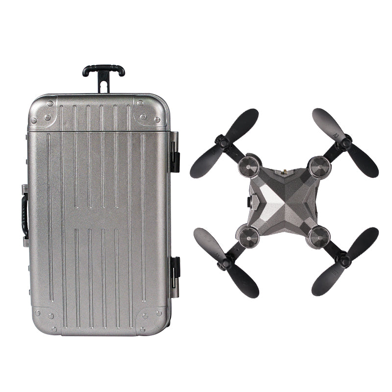 Silver suitcase and black drone on a white background