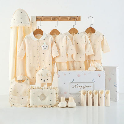 Baby clothing set with shirts, pants, and accessories on a white background