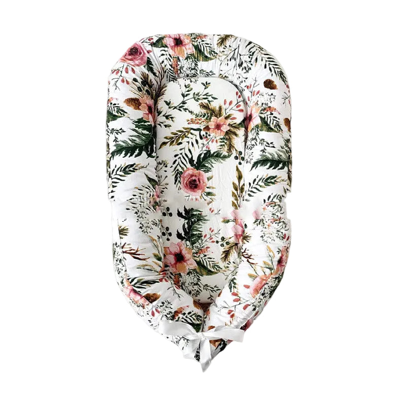 Floral-patterned baby nest on a gray background