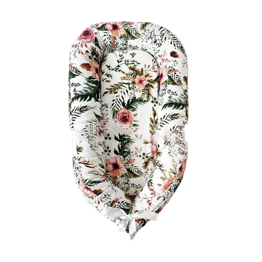 Floral-patterned baby nest on a gray background