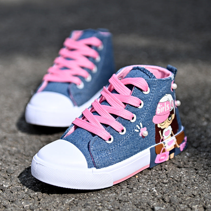 Pair of denim high-top sneakers with pink laces on a dark surface
