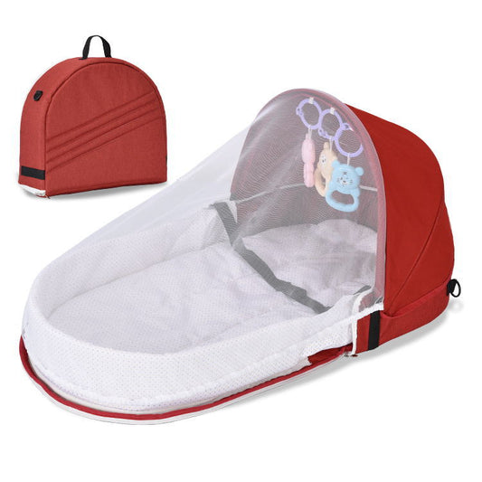 Red baby bassinet with mosquito net and backpack on a white background