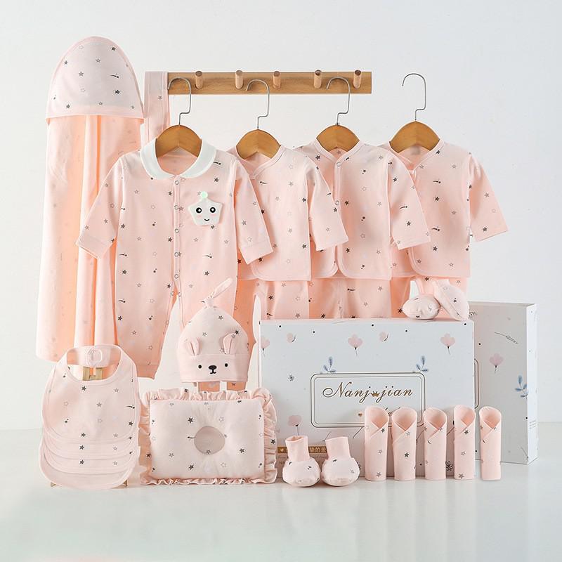 Baby clothing set with pink outfits, hats, and accessories on a white background