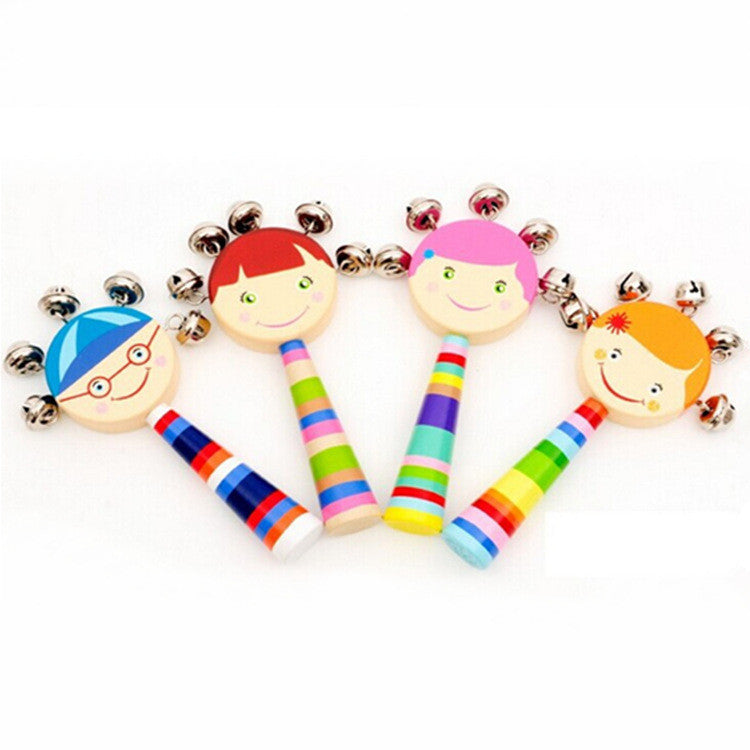Colorful wooden rattle toys with face designs on a white background