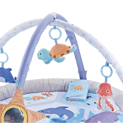 Baby play gym with ocean-themed toys and activities on a white background