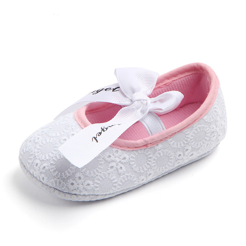 Baby shoe with white lace and pink interior on a white background